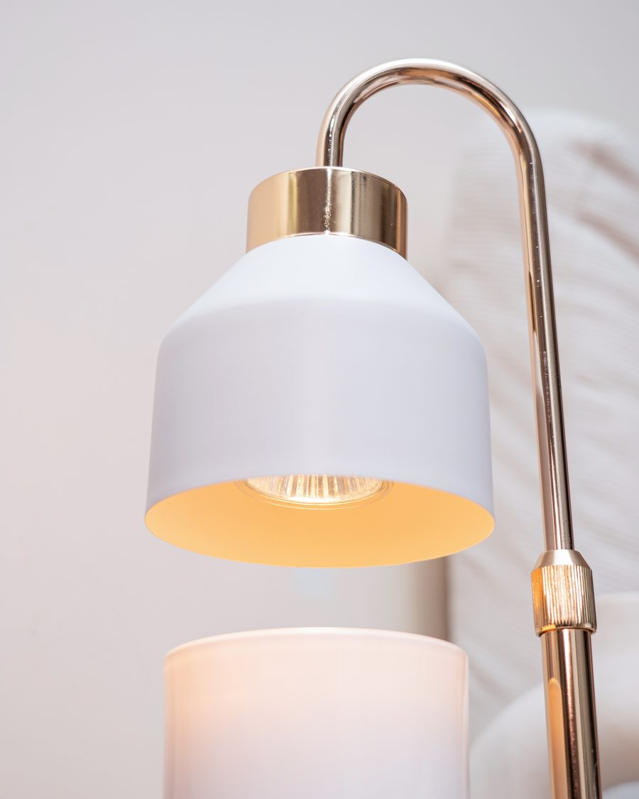 Rivo Monti candle warmer lamp, bulb glowing above a lit candle